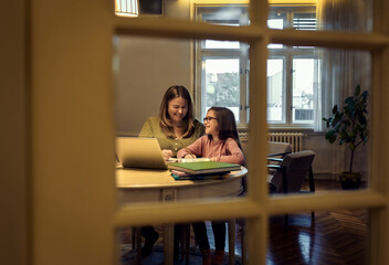 Mother and daughter learning together at home.