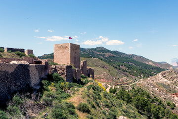 Fototapeta premium exterior view of part of the wall and tower of the medieval castle of Lorca Murcia Spain, located on top of a hill with privileged views for its defense