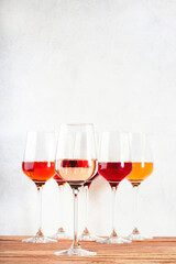 Rose wine glasses set on wine tasting. Different varieties, colors and shades of pink wines on white background