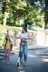 Mother and daughter talking and walking trough nature.