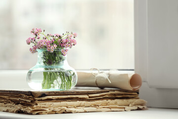 Beautiful Forget-me-not flowers and old book on window sill. Space for text - Powered by Adobe