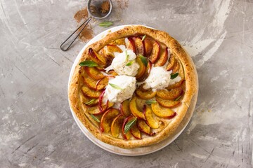 hot, homemade pie with peaches on a gray background. healthy food, comfort, holiday, vacations, dessert concept.