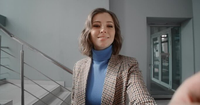 Young woman uses an interactive scoreboard in the office's lobby, woman inserts the pincode on the cash machine, usage of the ATM at public place, 4k Prores HQ