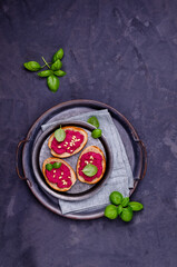 Three sandwiches with beetroot paste