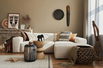 Stylish ethnic living room interior with design modular sofa, wooden stool, moroccan shelf, carpet...