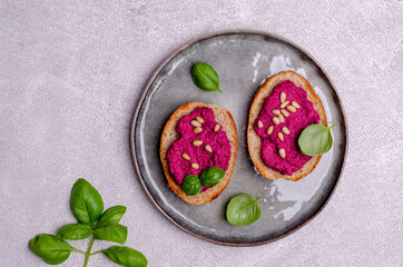 Three sandwiches with beetroot paste