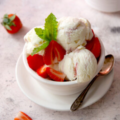Ice cream strawberry scoop in bowl with fresh strawbery and mint