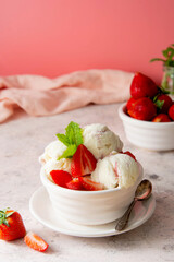 Summer food. Strawberry ice cream scoops in bowl with fresh strawberry fruits. Delicious dessert.