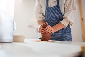 Close up of potter working with fireclay