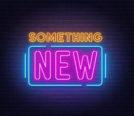 Something new neon sign on brick wall background.