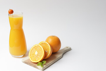 Bottle with fresh orange juice and mint.