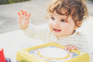 Little baby enjoying the day playing with her toys