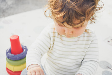 Little baby enjoying the day playing with her toys