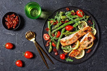 grilled salmon fillets with lemon, bacon,vegetables