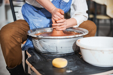 Close up of woman demonstrating master class in pottery