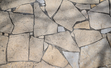 Texture of a stone wall. Old castle stone wall texture background. Stone wall as a background or texture. An example of masonry as a cladding of external walls.