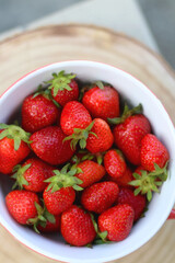 Bowl of fresh strawberries on a table. Top view.