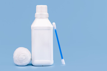 Plastic bottle for hydrogen peroxide, blue background, medicine concept, with copy space