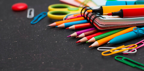 School supplies top view on the background of the chalkboard.