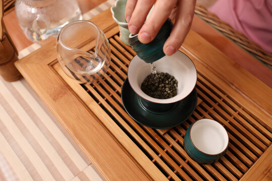 Master conducting traditional tea ceremony at table, closeup