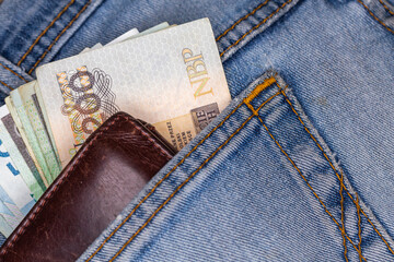 Wallet and lots of Polish banknotes sticking out of the back pocket of denim pants. Photo taken...