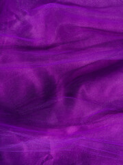 Fototapeta na wymiar Purple tulle fabric texture top view. Violet background. Fashion trendy color feminine tutu skirt dress flat lay, female blog glossy backdrop text sign design. Girly abstract wallpaper,textile surface