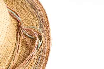A bright straw hat isolated on a white background. Photo taken under artificial, soft light