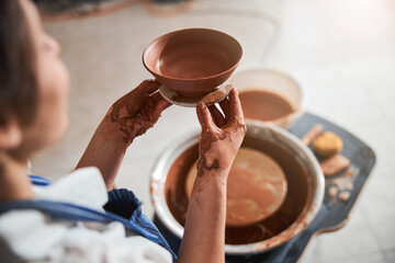Fototapeta na wymiar Focused photo on hands that holding clay bowl