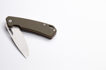 A small folding hunting knife isolated on the white background. Photo taken under soft artificial light.