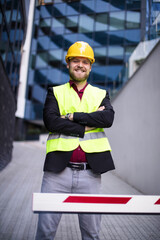 Smiling engineer standing on the street. Cloe up.