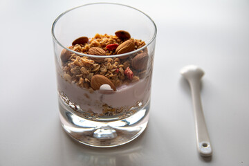 Isolated photo of diet yogurt with granola and almond, healthy breakfast concept with muesli or cereal
