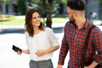 Happy young couple outdoors. Loving couple walking in the city