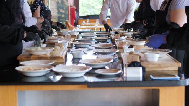 The general plan is a lot of gloved hands cooking a cutlet. The elite restaurant