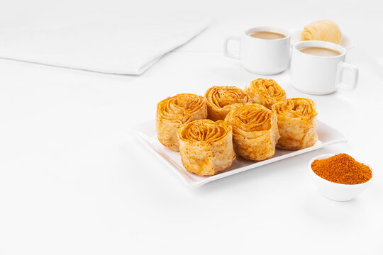 chirote or chiroti karnataka based sweet theme based picture with tea on white background