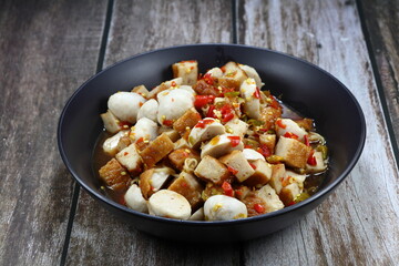 Spicy cutting pork ball with pickled fish sauce serving on the plate. Famous appetizer menu in Asia restaurant. 