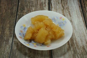 Pile of sweet potato or Tapioca in syrup serving on the plate. Famous ancient Thai dessert in Asia restaurant. 
