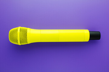 Yellow professional vocal wireless microphone on purple background.