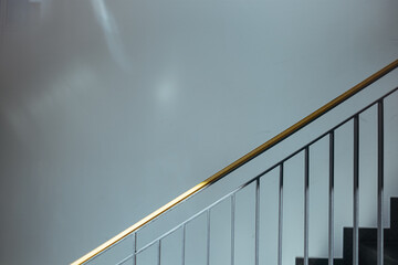 stairs with wooden handrail in sunlight