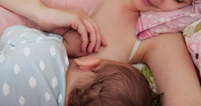 Woman breastfeeding newborn baby. Baby eating mother's milk. Concept of lactation infant