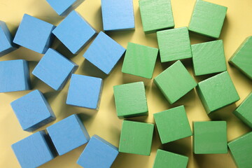 the concept of green and blue wooden cubes