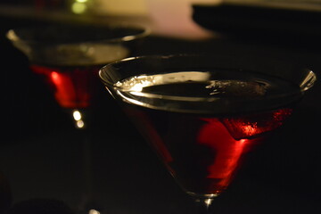 Red alcohol cocktail in triangular glasses for a couple celebrating romantic night