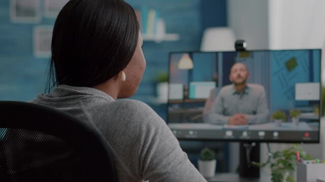 African american student discussing with college entrepreneur during online videocall telework meeting conference. Woman working remote from home having teleconference marketing university webinar