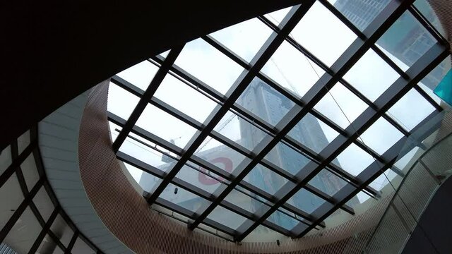 Kuala Lumpur, Malaysia - 15 April 2021 Modern shopping mall architecture interior ceiling overlooking outdoor buildings industrial under construction....