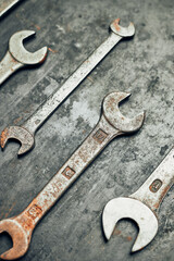 Spanners on steel surface. Old rusty wrenches for maintenance. Mechanic hardware tools to fix. Technical tools background