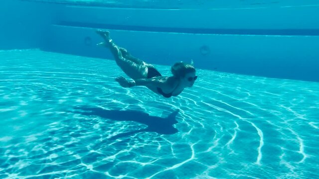 Young pretty bikini swimming underwater 