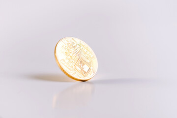 Reverse Of A Bitcoin Coin Spinning On A White Table. Copy Space. White Background.