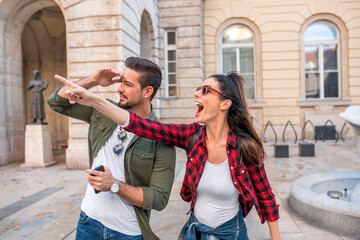 A beautiful couple making exciting discovering in a European city