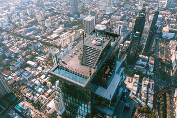 Aerial view of Sathorn district during covid lockdown quarantine, Chong Nonsi, King Power Mahanakhon tower and skywalk in Bangkok, Thailand