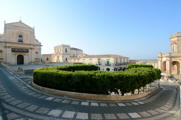 the wonderful summer light on the steps of the baroque cathedral dedicated to San Corrado and the...