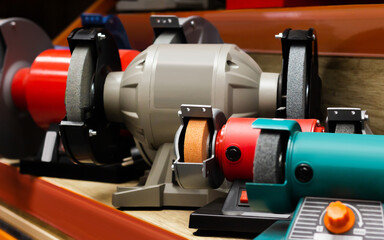 Photo of various type table grinder tools standing on construction supply store shelf.